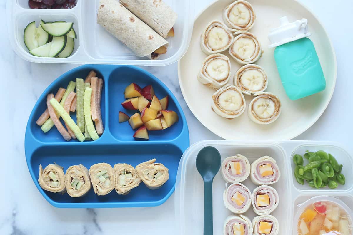 wraps for kids on plates and lunchboxes on counter