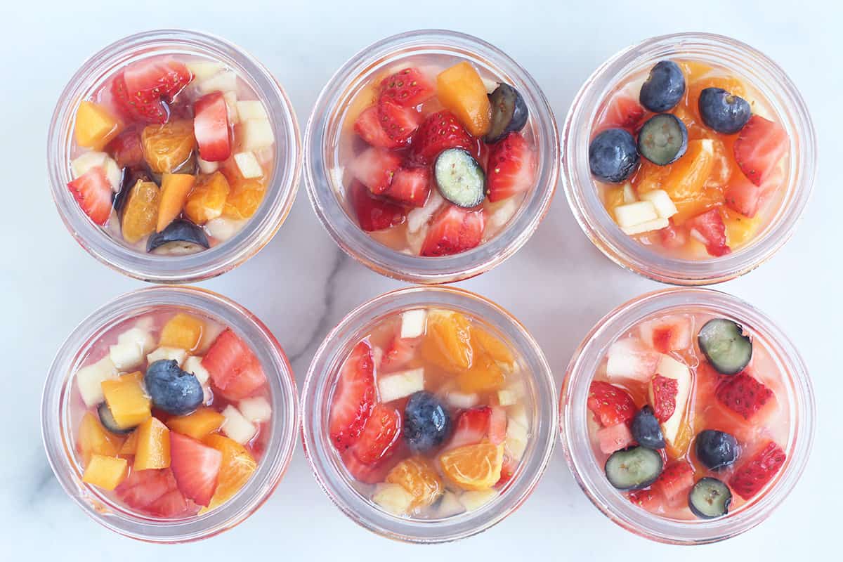 fruit cups in glass jars on counter
