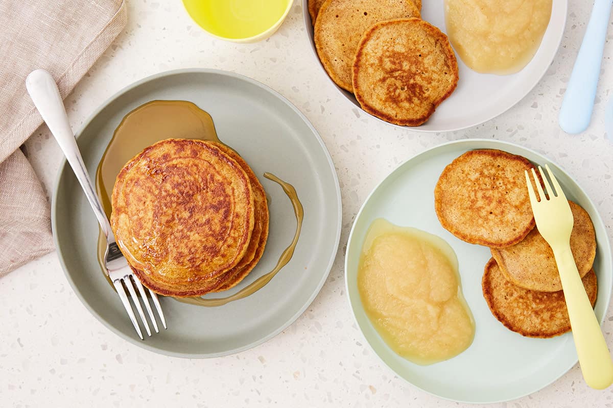 sweet potato pancakes on plates with applesauce