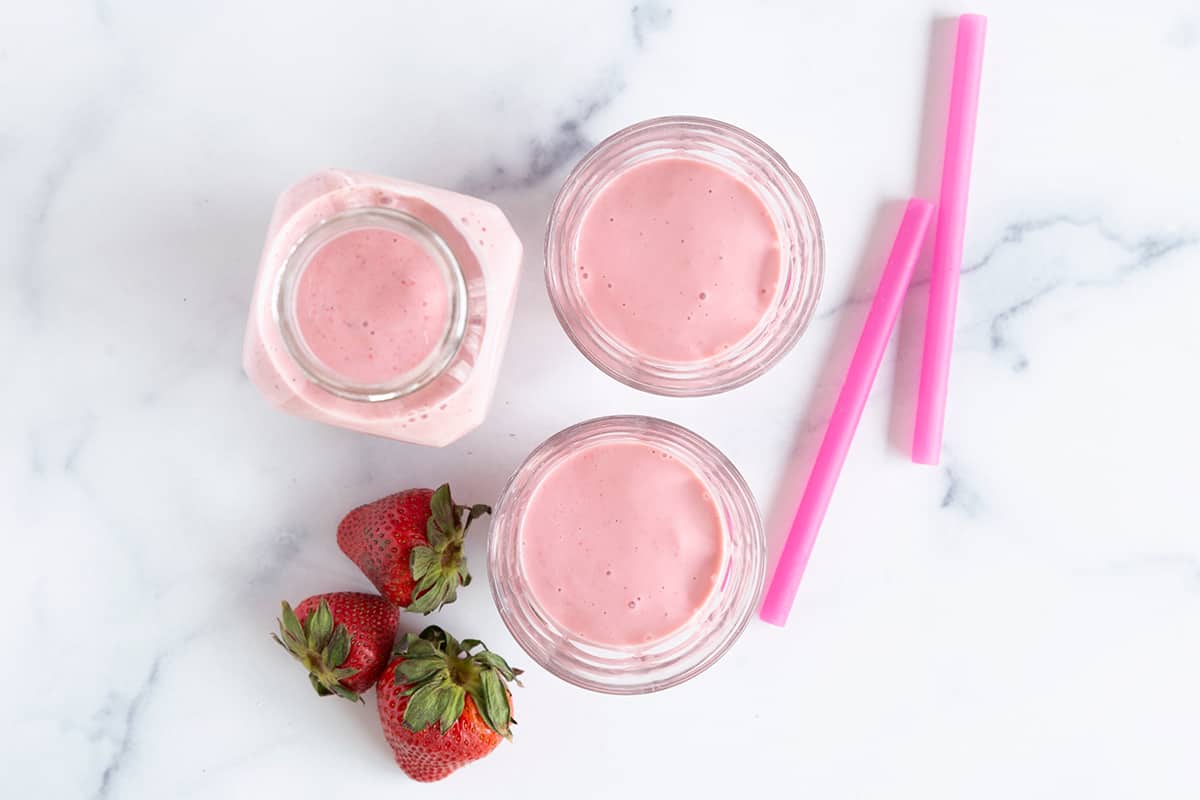 strawberry-smoothie-in-cups-on-counter
