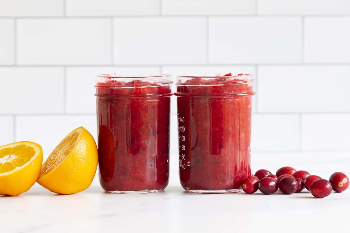Cranberry orange sauce in two glass jars.
