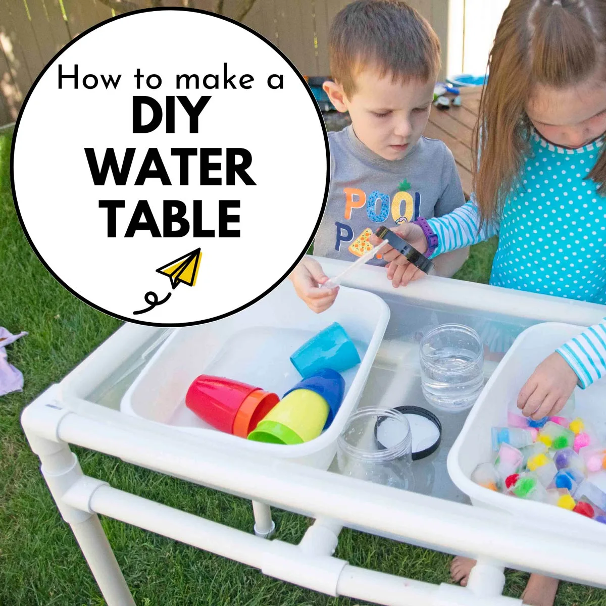 How to make a PVC Pipe Water Table: two children are playing at a DIY water table.