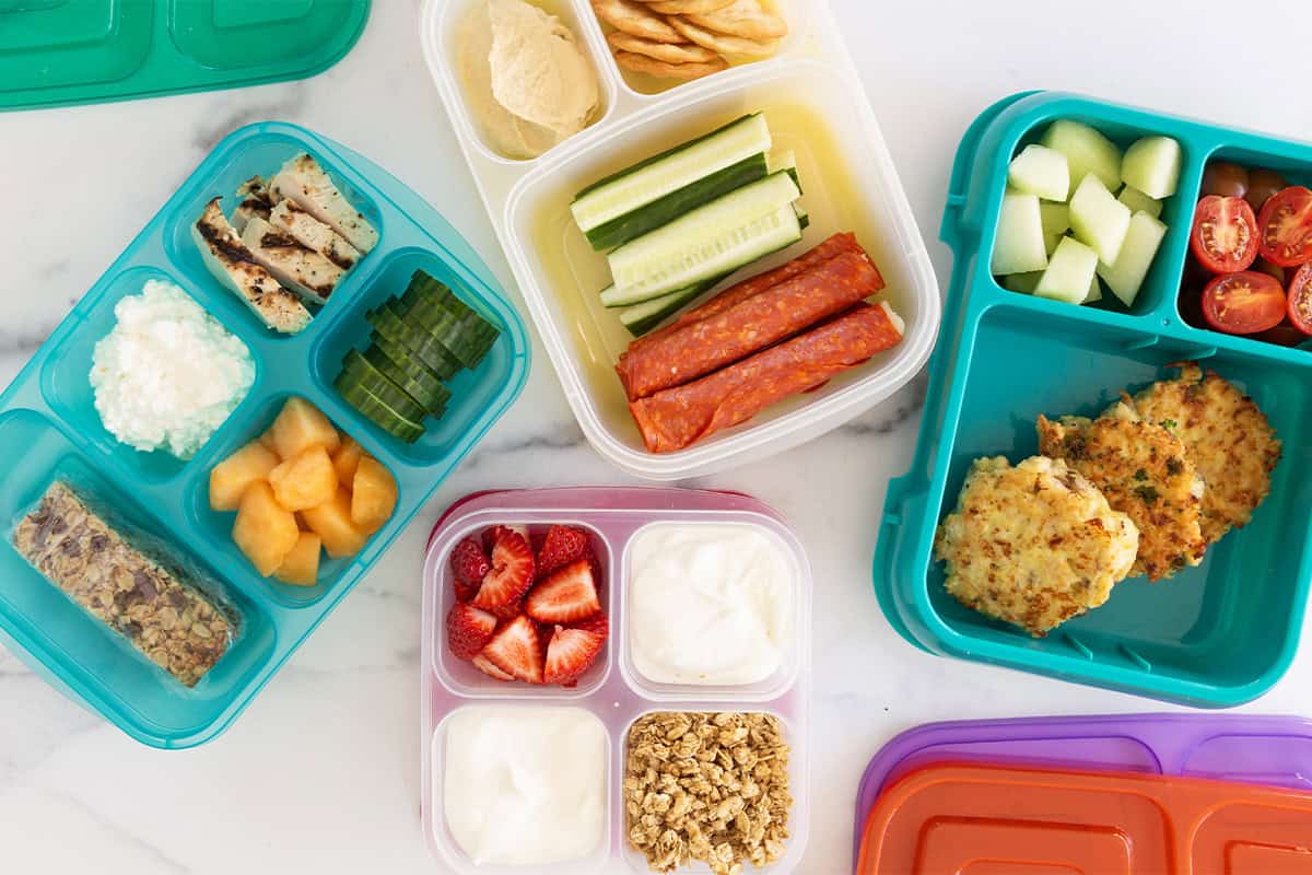 chicken caesar pasta salad in bowl and lunch boxes.