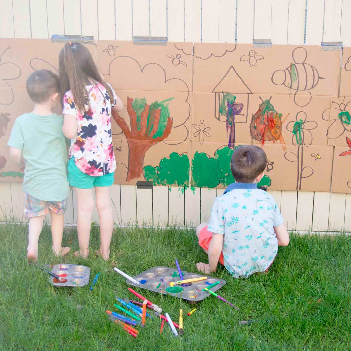 An 18 month old paints on an outdoor easel. How to build an outdoor easel (text)